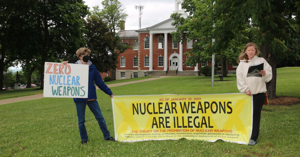 2 women activists in front of Nuclear Weapons are Illegal banner